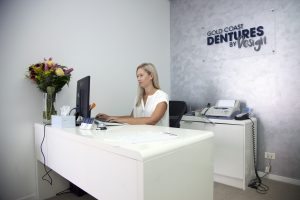 Dr Lericha Harrington answering emails of patients who have questions about dentures